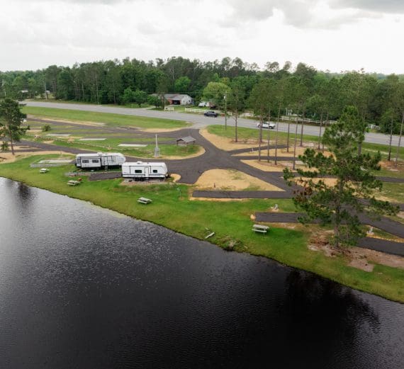 A lakeside campground with RVs and winding roads.